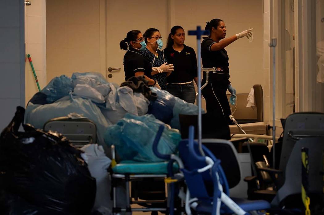 Hospital employees work next to medical equipments at the Badim Hospital, where a fire left at ...