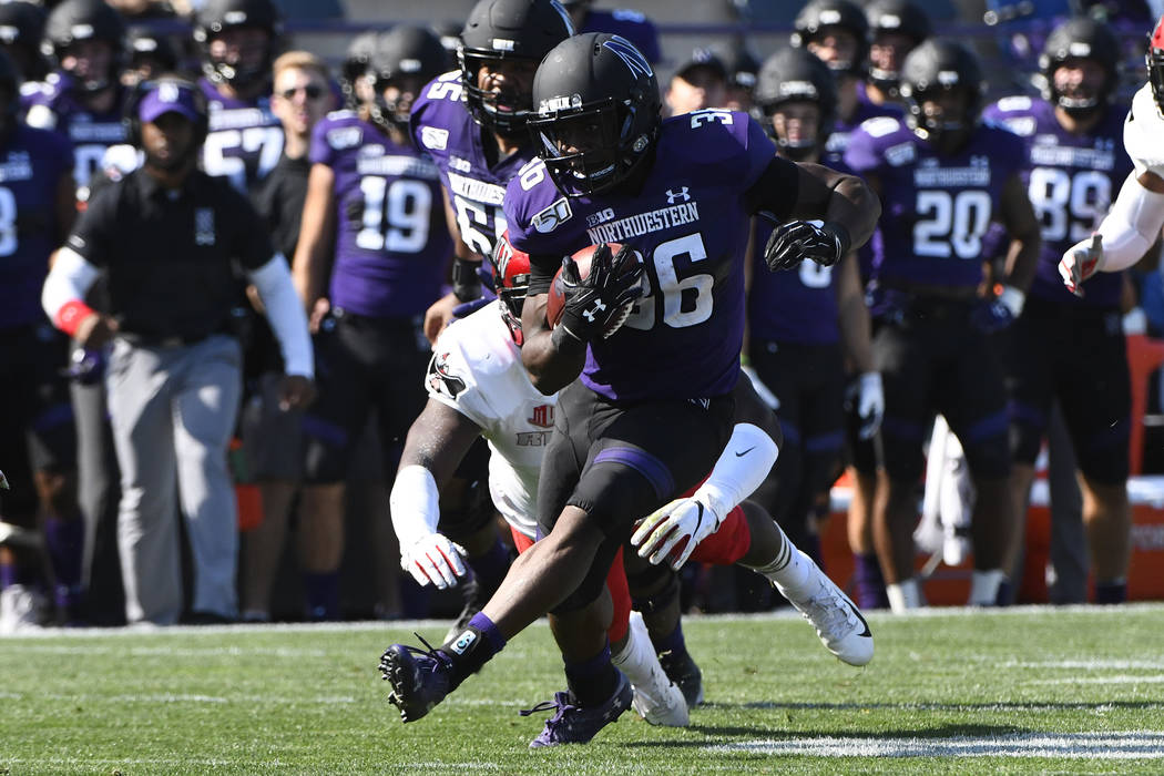 Northwestern running back Jesse Brown (36) is chased by UNLV defensive back Tykenzie Daniels (6 ...