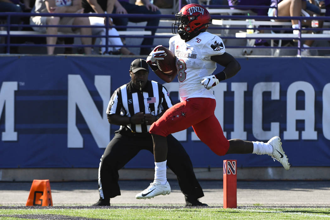 UNLV running back Charles Williams (8) runs for a touchdown against Northwestern during the fir ...