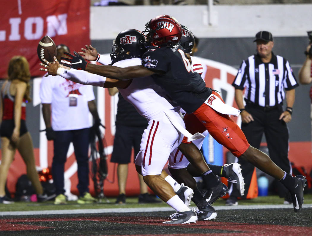 Arkansas State Red Wolves defensive back B.J. Edmonds, left, blocks a pass intended for UNLV Re ...