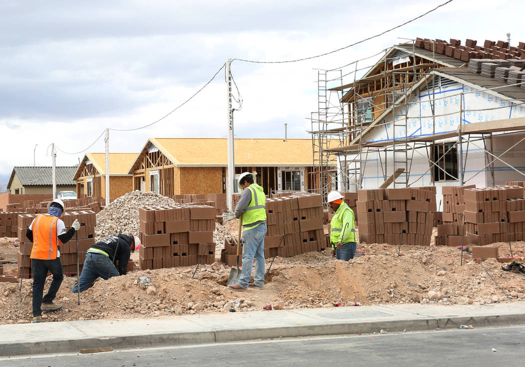 Construction workers build wall during the new construction of LGI Homes at the Intersection of ...