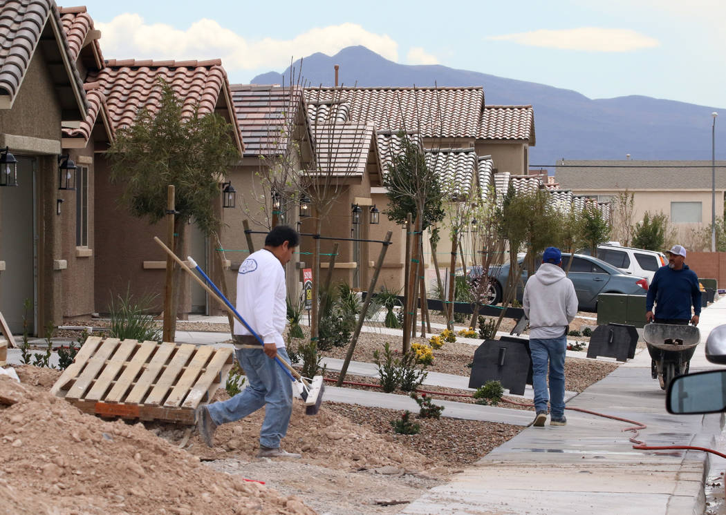 Construction workers at a new LGI Homes construction site at the Intersection of E. Lake Mead B ...