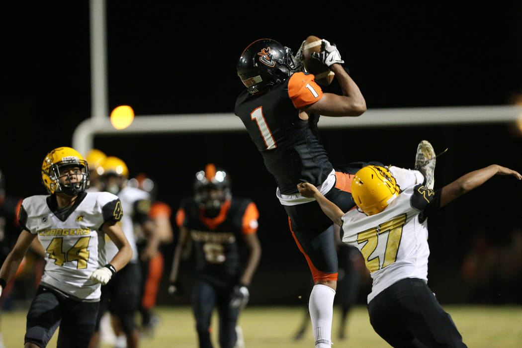 Chaparral's Iopu Tauli'ili (1) makes a catch in the second quarter against Clark's Taumafai Teo ...