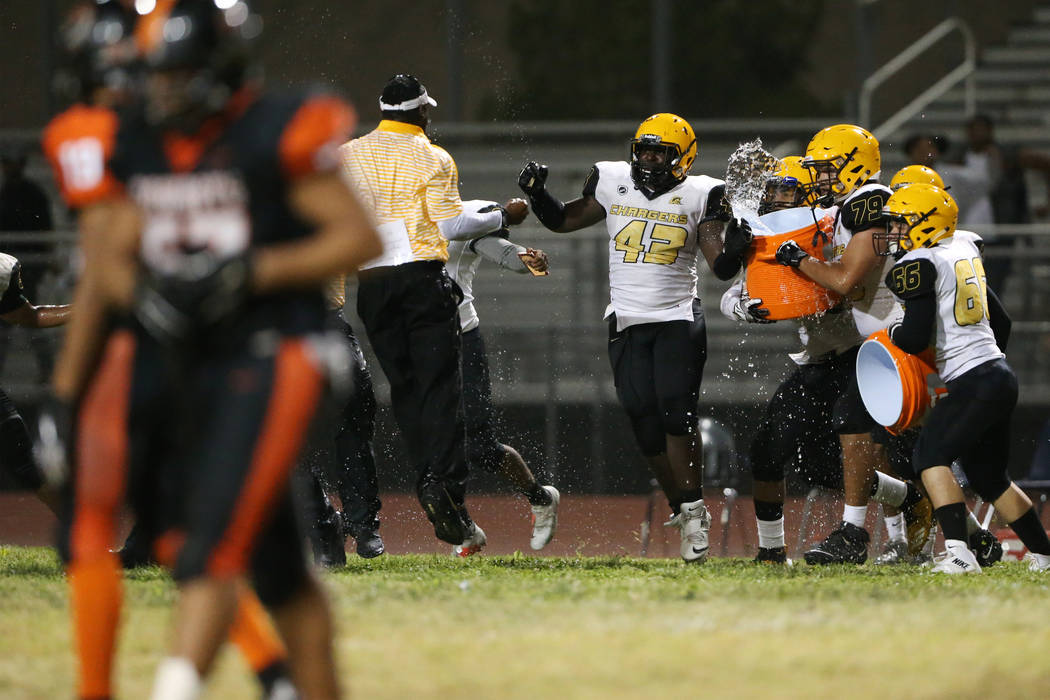 Clark's Felix Makwashi (43), Pablo Cortez (79), and Mauricio Garcia (66) celebrate their 27-20 ...