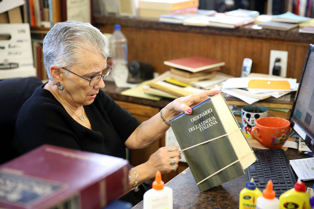 Myrna Donato, owner of Amber Unicorn Books at 2101 S. Decatur Blvd. in Las Vegas, repairs a boo ...