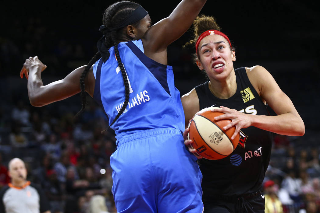 Las Vegas Aces' Dearica Hamby moves the ball around Atlanta Dream's Elizabeth Williams (1) duri ...