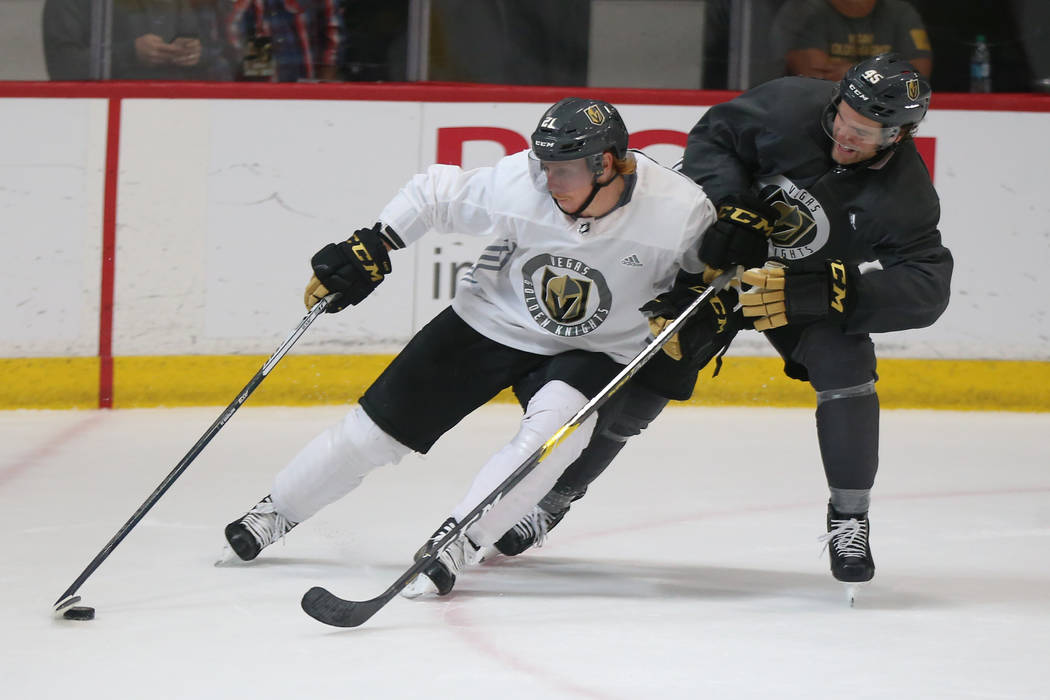 Vegas Golden Knights center Cody Eakin (21) and defenseman Jake Bischoff (45) go for the puck d ...