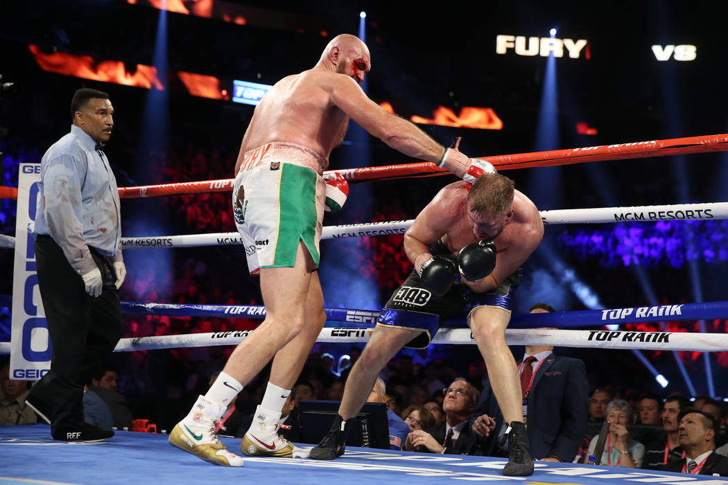 Tyson Fury, left, battles Otto Wallin in the heavyweight bout at T-Mobile Arena in Las Vegas, S ...