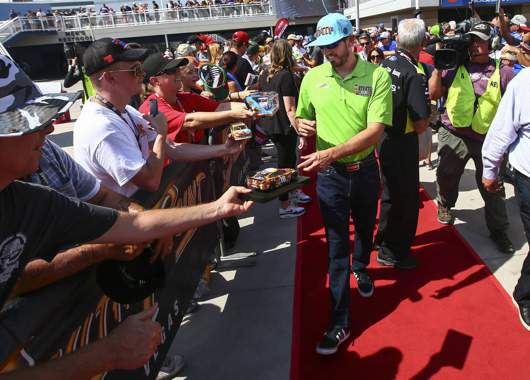 Martin Truex Jr. (19) does a burnout after winning a NASCAR Cup Series auto race at the Las Veg ...