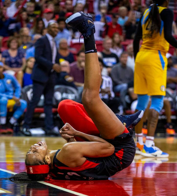 Las Vegas Aces center A'ja Wilson (22) rolls on the ground in celebration after a big shot over ...