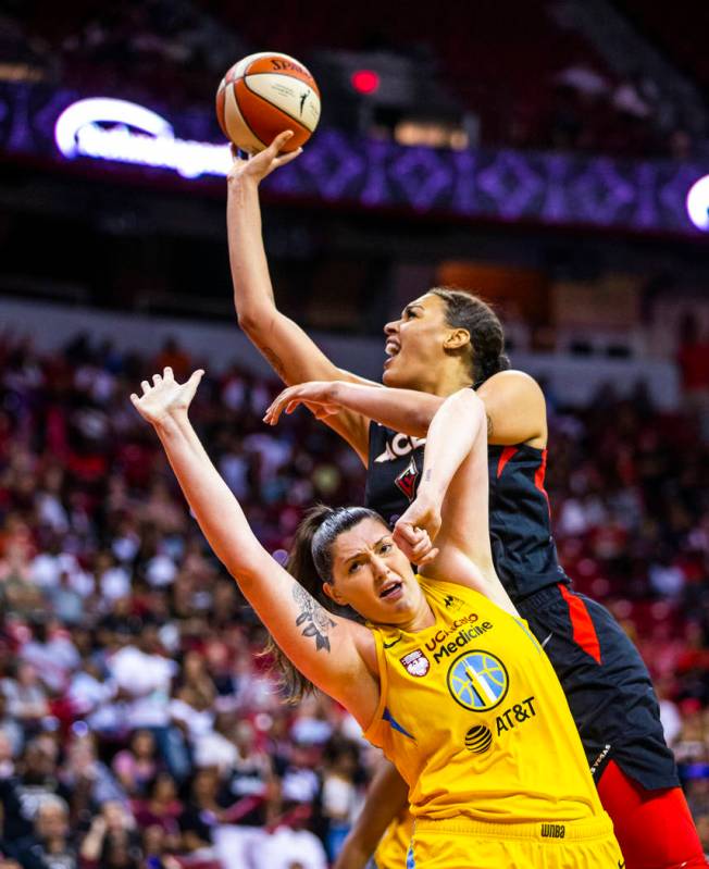 Las Vegas Aces center Liz Cambage (8, above) looks to get off a shot over the defense of Chicag ...