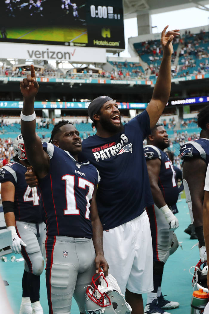 New England Patriots wide receiver Antonio Brown (17) and defensive end Deatrich Wise, celebrat ...