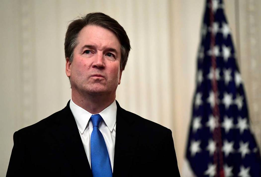 In this Oct. 8, 2018, file photo, Supreme Court Justice Brett Kavanaugh stands before a ceremon ...