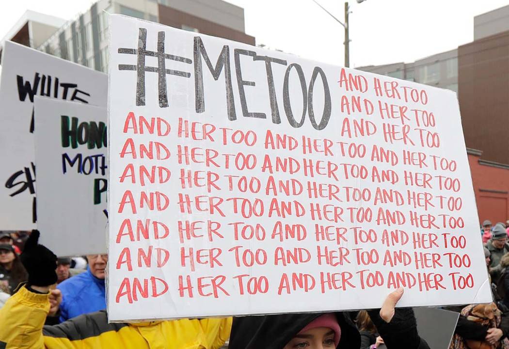 In this Jan. 20, 2018 file photo, a marcher carries a sign with the popular Twitter hashtag #Me ...