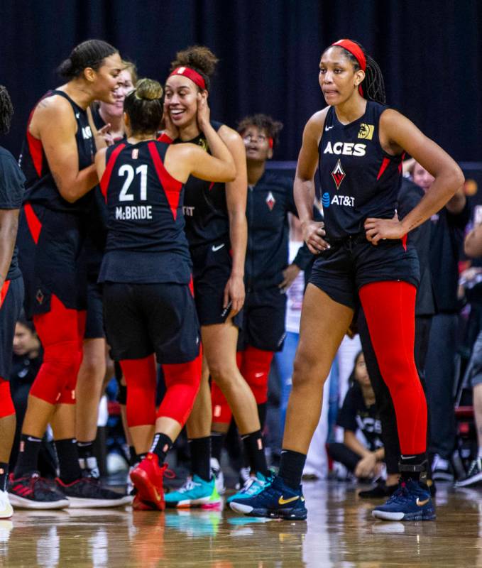 Teammates congratulate Las Vegas Aces forward Dearica Hamby (5) after making a late-game three- ...