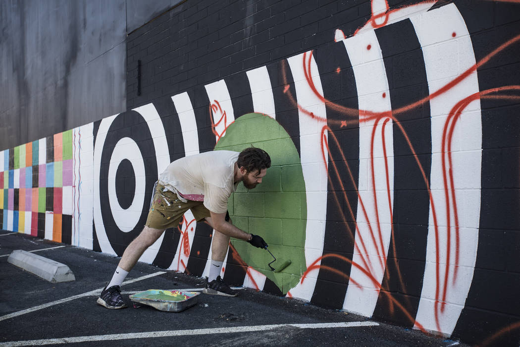 Artist Eric Vozzola works on his mural "An Allegory of Natural Beauty" for the Life is Beautifu ...