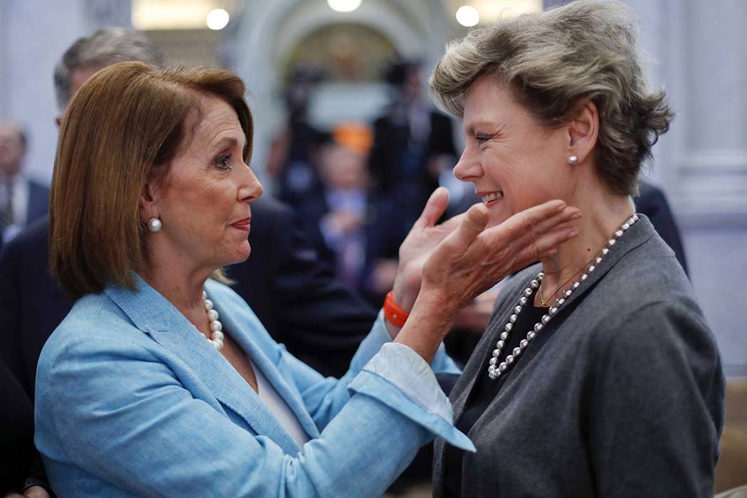 House Democratic Leader Nancy Pelosi, left, of Calif., greets journalist Cokie Roberts, right, ...