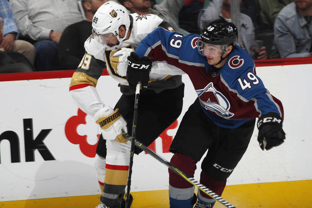 Colorado Avalanche defenseman Samuel Girard, right, fights to slow down Vegas Golden Knights ri ...