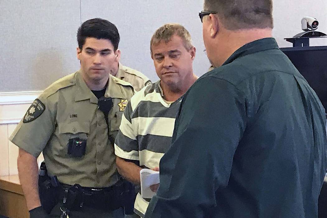 Churchill County sheriff's deputies lead John K. O'Connor from the courtroom, July 25, 2018, in ...