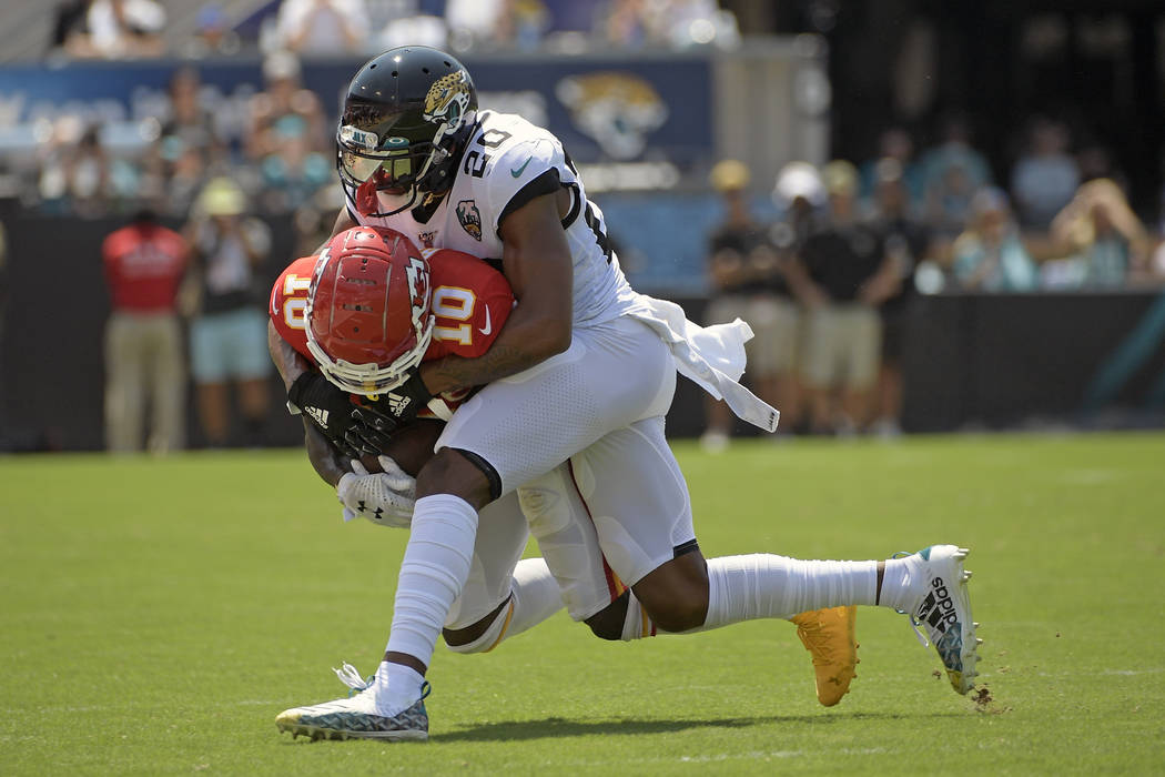 Kansas City Chiefs wide receiver Tyreek Hill (10) is stopped by Jacksonville Jaguars cornerback ...