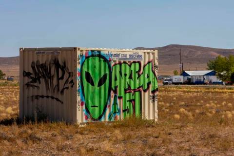 A storage container with alien and Area 51 markings sits across the street from the Little A'Le ...