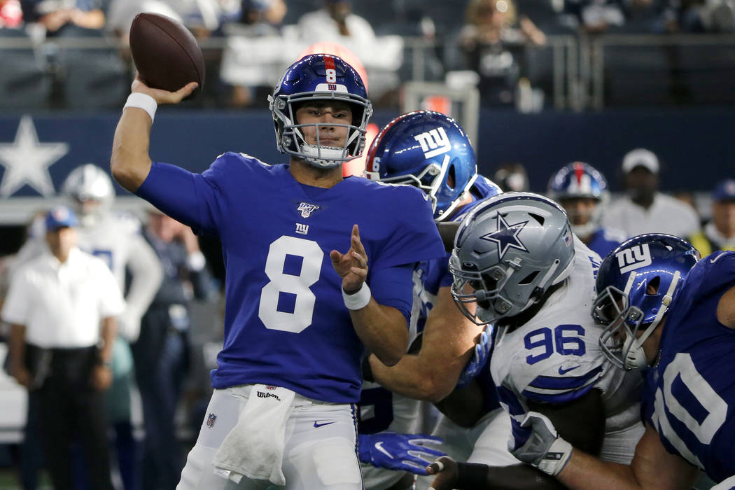 New York Giants quarterback Daniel Jones (8) throws a pass under pressure from Dallas Cowboys d ...