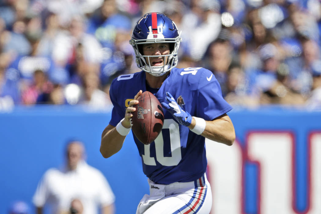 New York Giants quarterback Eli Manning looks to throw during the first half of an NFL football ...