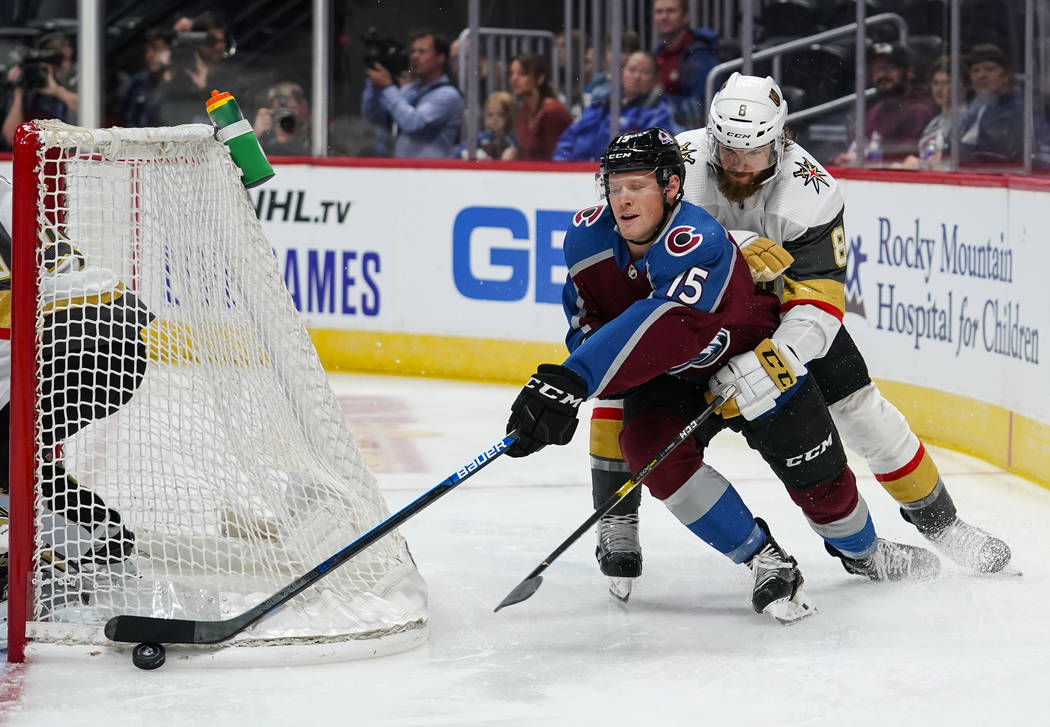Colorado Avalanche center Sheldon Dries (15) moves the puck behind the net against Vegas Golden ...