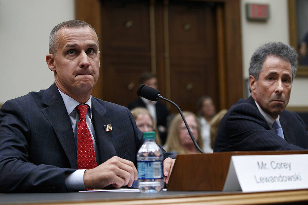 Attorney Peter Chavkin, right, takes a seat at the witness table with his client, Corey Lewando ...