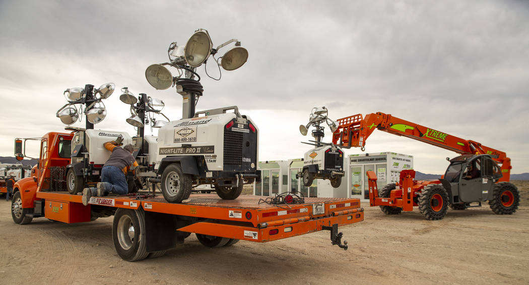 A crew with Ahern Rentals unloads equipment in the Area 51 Basecamp about the Alien Research Ce ...