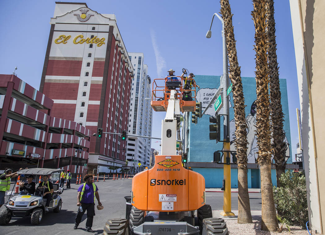 Big Vision entertainment workers Noah Wynia, top/center, and Shane Smith run fiber for camera a ...