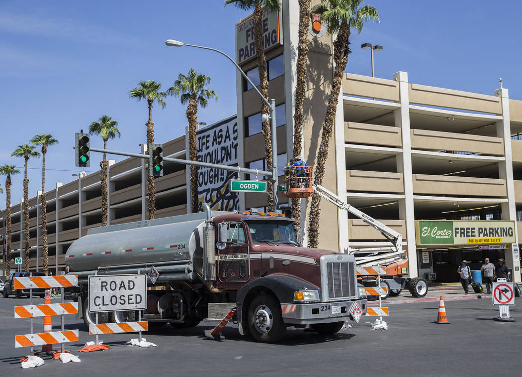 Workers at the intersection of North 7th Street and East Ogden Avenue prepare the area for Life ...