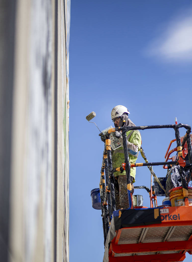 French painter Mantra works on his mural in preparation for Life is Beautiful music festival in ...