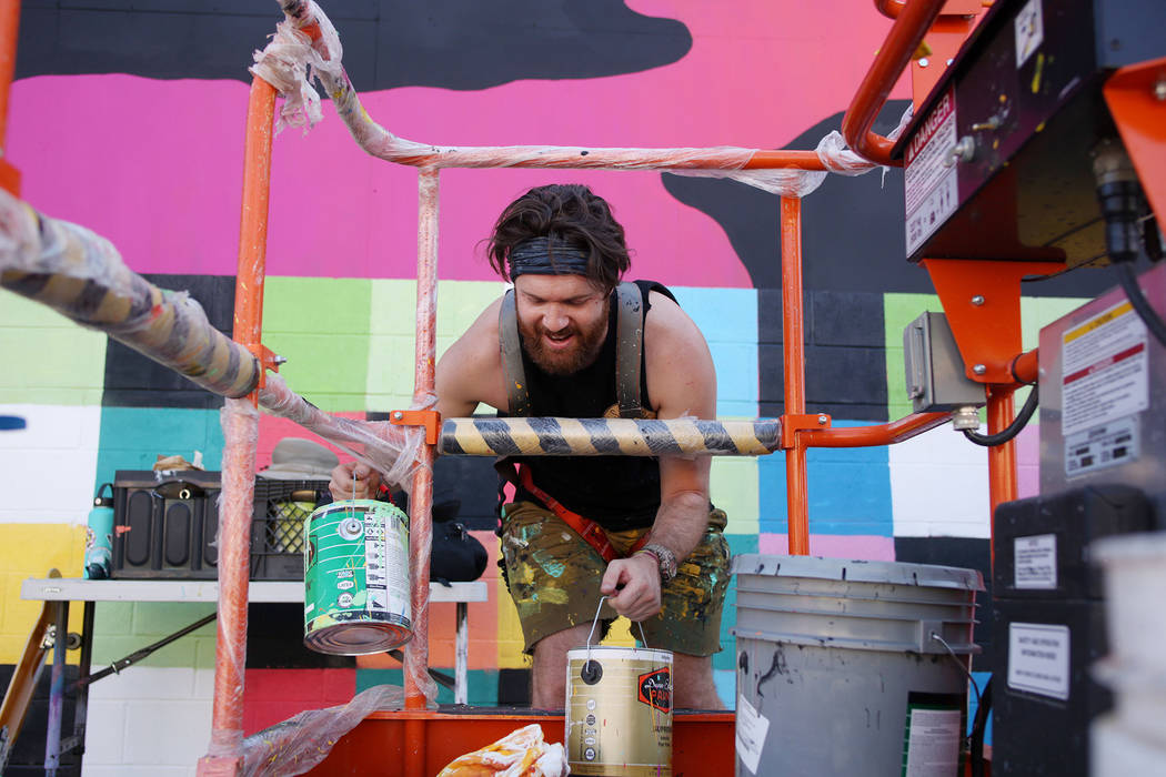 Local Las Vegas artist Eric Vozzola works on his mural in preparation for Life is Beautiful mus ...