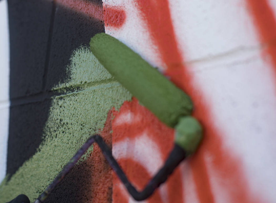 Artist Eric Vozzola works on his mural "An Allegory of Natural Beauty" for the Life i ...