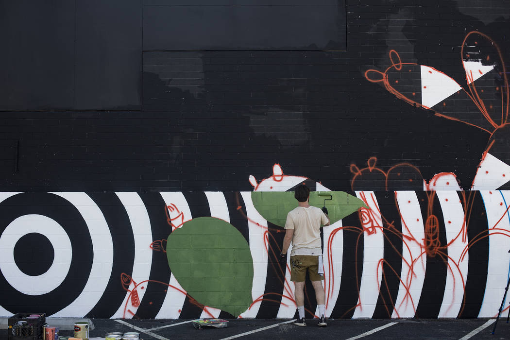 Artist Eric Vozzola works on his mural "An Allegory of Natural Beauty" for the Life i ...