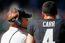Oakland Raiders quarterback Derek Carr (4) and head coach Jon Gruden stand on the sidelines dur ...