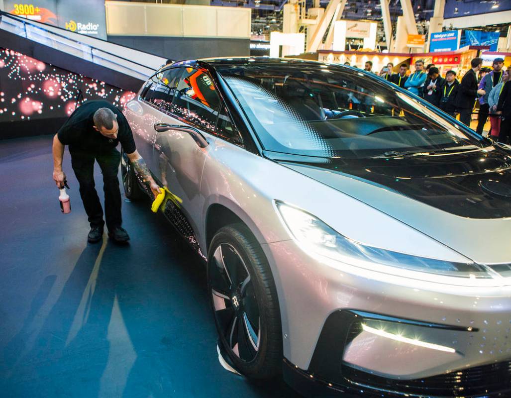 A man wipes down Faraday Future's concept car during CES 2017 in the Las Vegas Convention Cente ...