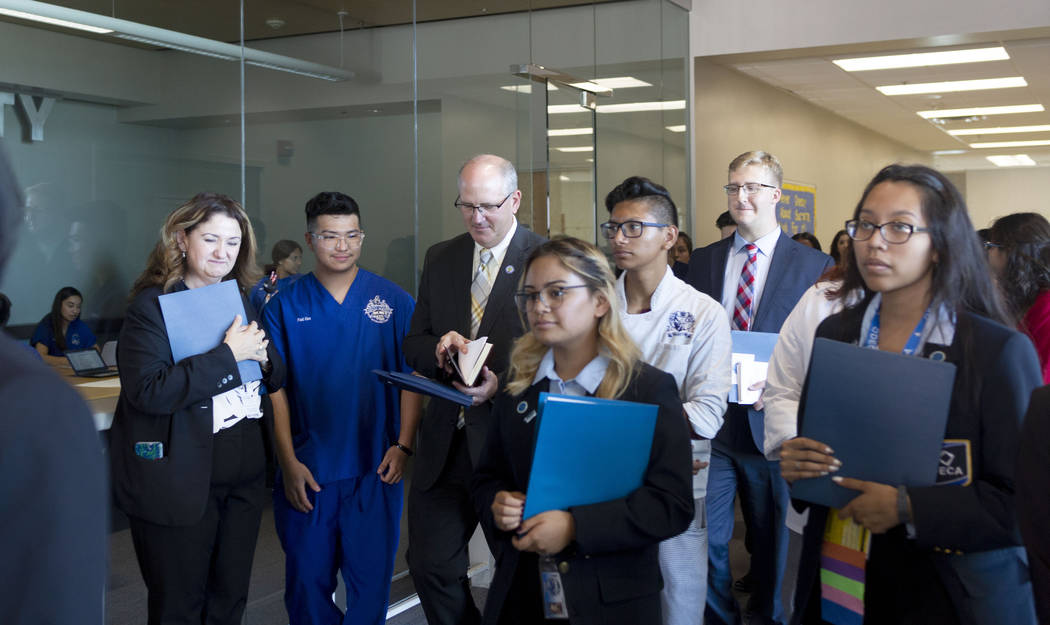 Assistant U.S. Secretary of Education Scott Stump, third from left, and his staff receive a tou ...