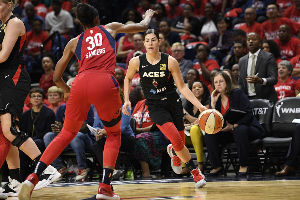 Las Vegas Aces guard Kelsey Plum, right, dribbles the ball against Washington Mystics forward L ...