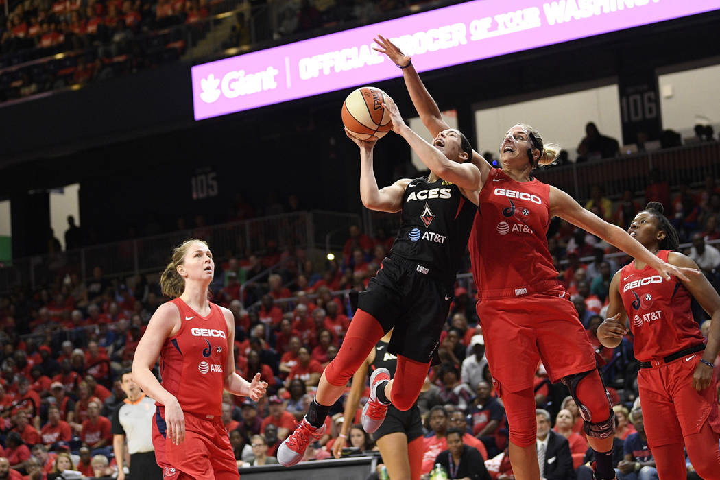 Las Vegas Aces guard Kelsey Plum, second from left, goes to the basket against Washington Mysti ...