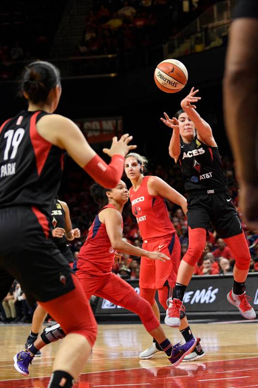 Las Vegas Aces guard Kelsey Plum, right, passes the ball toward center Ji-Su Park (19), past Wa ...