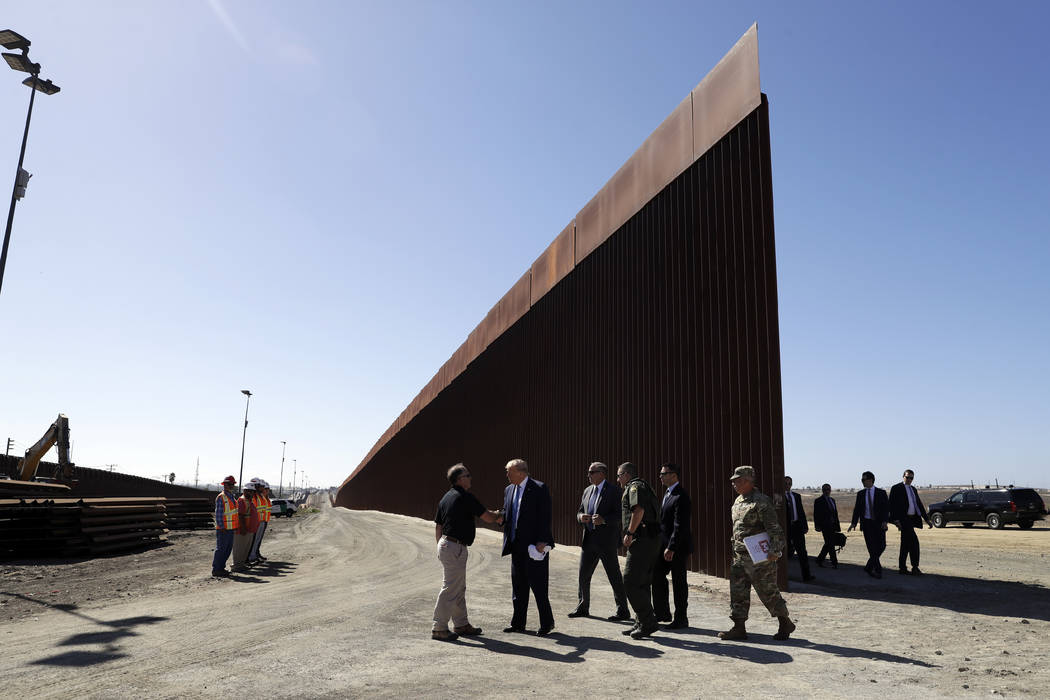 President Donald Trump tours a section of the southern border wall, Wednesday, Sept. 18, 2019, ...