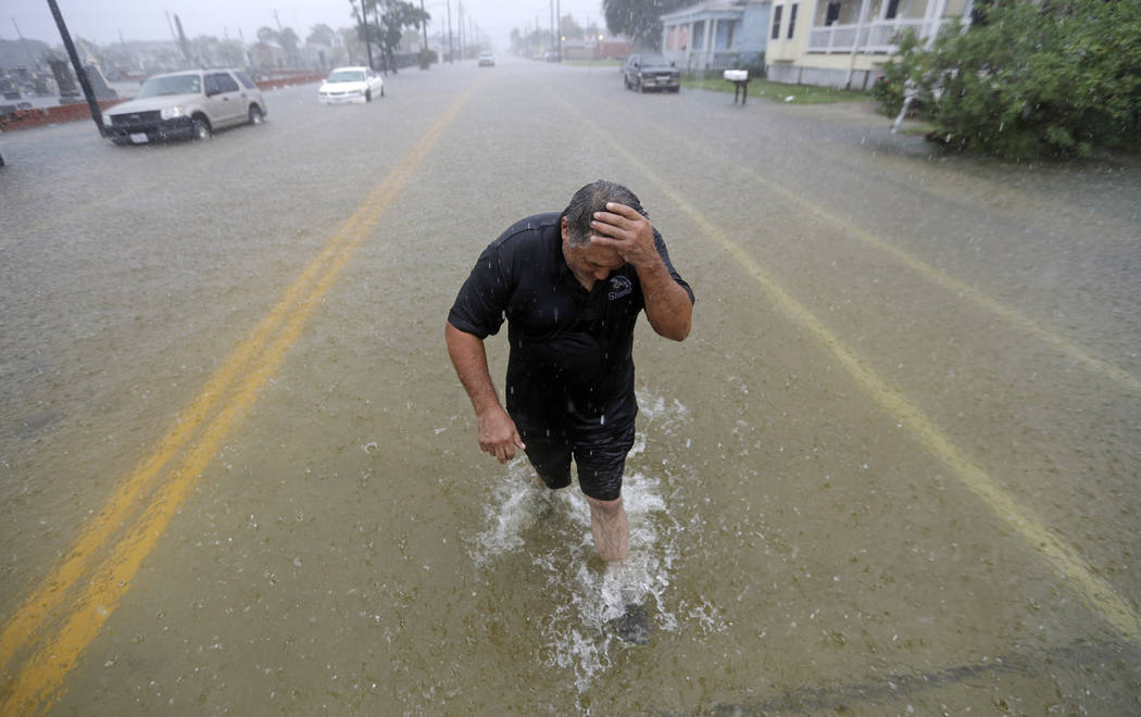 Angel Marshman wades through floodwaters from Tropical Depression Imelda after trying to start ...