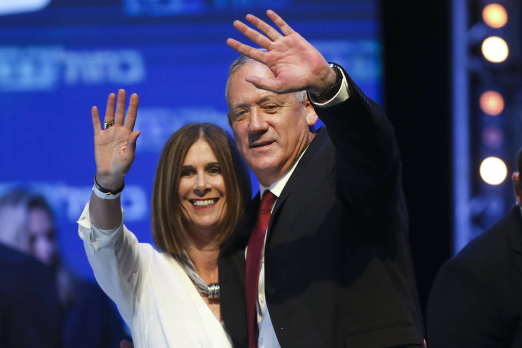 Blue and White party leader Benny Gantz and his wife Revital wave to supporters at party headqu ...