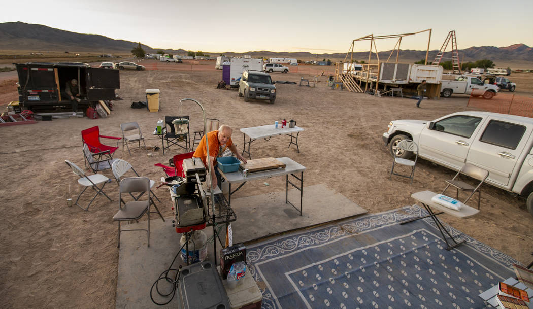 George Morrow readies the site about his camper for serving breakfast to the stage construction ...