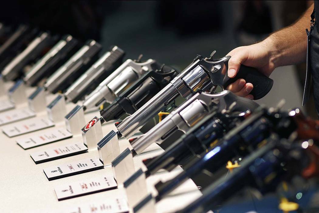 Handguns are displayed at the Smith & Wesson booth at the Shooting, Hunting and Outdoor Trade S ...