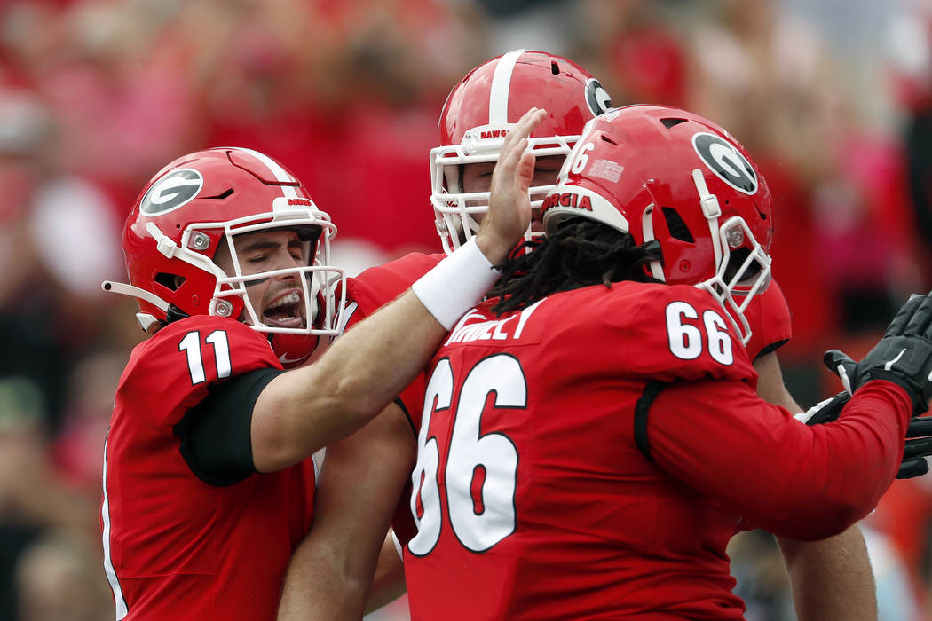 Georgia quarterback Jake Fromm (11) celebrates with offensive lineman Solomon Kindley (66) afte ...