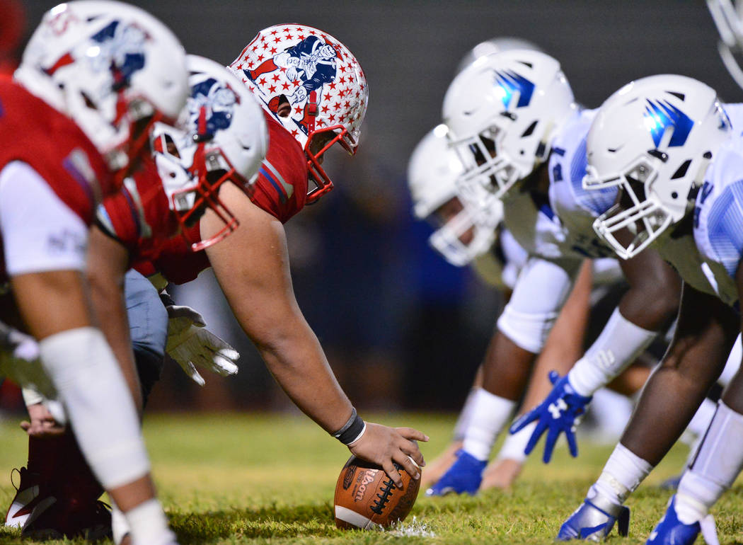 Liberty center Jeremiah Taiese (75) gets ready to snap the ball during a game against IMG Acade ...