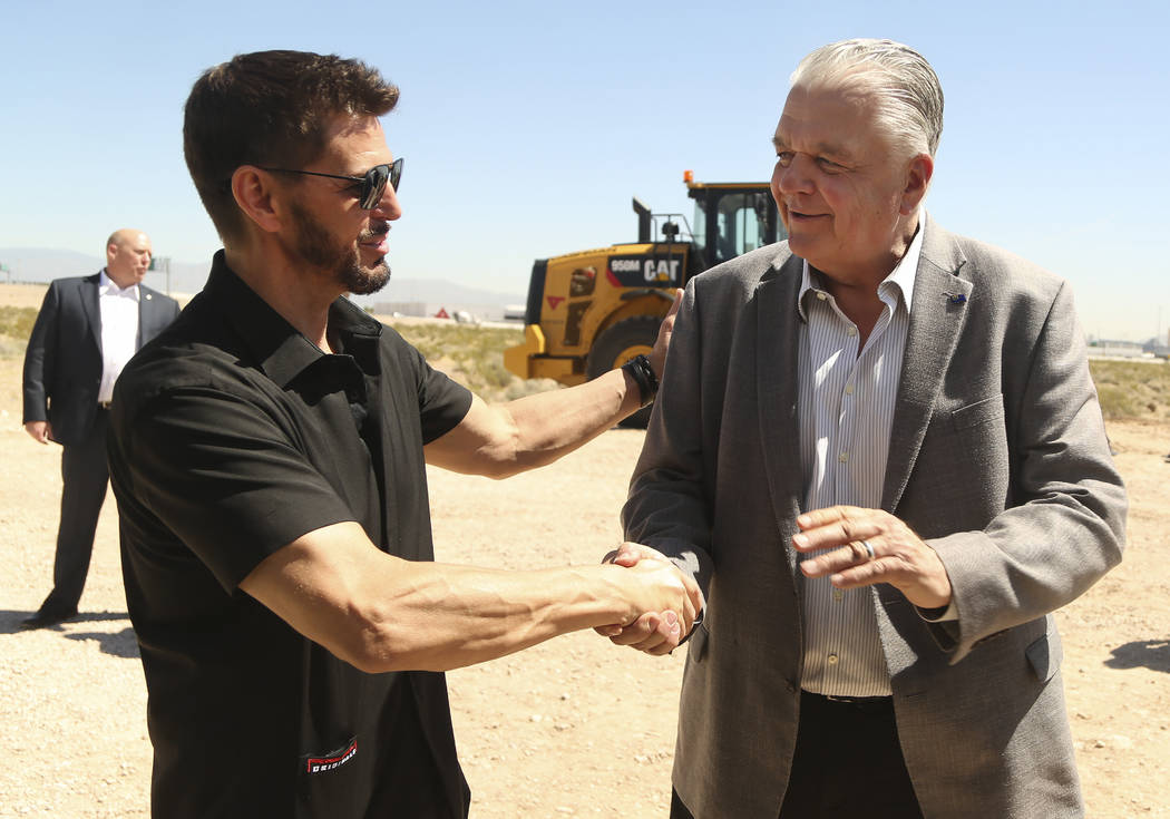 Switch CEO Rob Roy, left, shakes hands with Nevada Gov. Steve Sisolak during a ceremonial groun ...